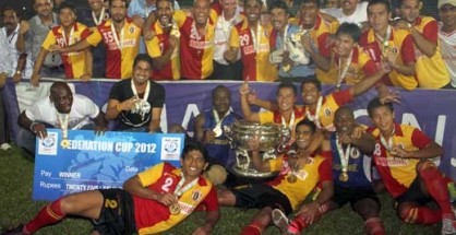 East Bengal players celebrate with the trophy.