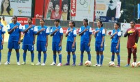 Indian women stand for the National Anthem.